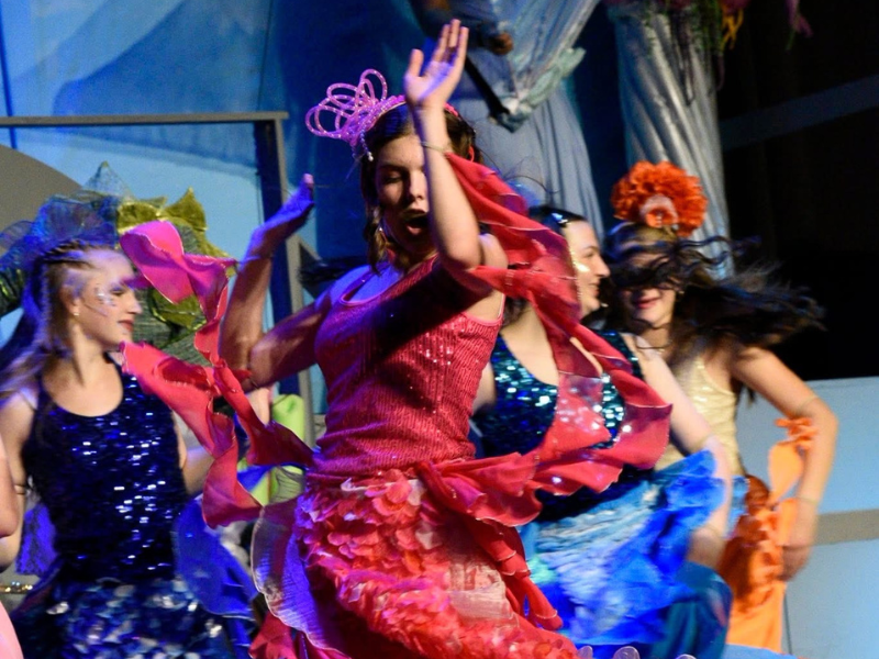 Image shows a group of dancers on stage